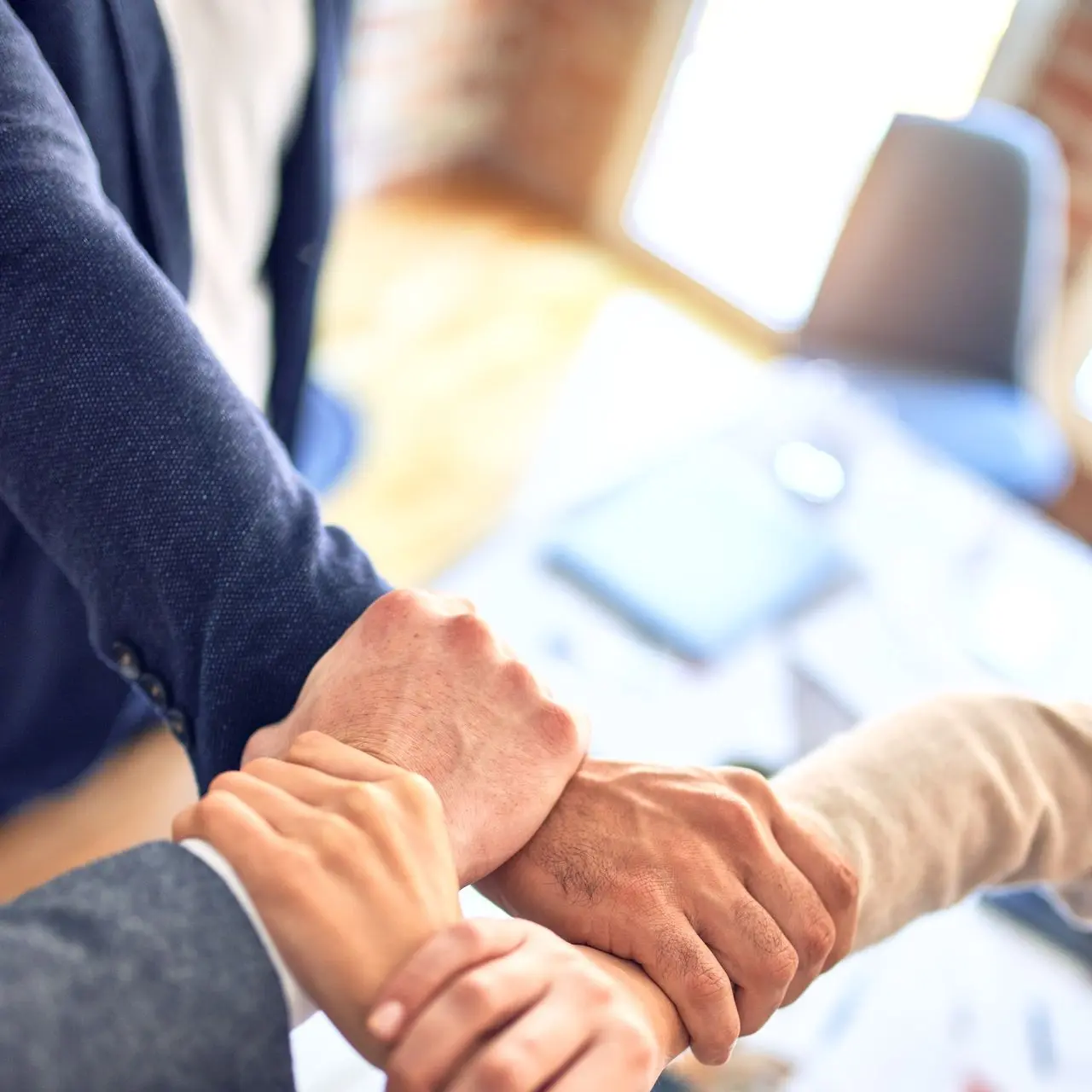 person in black long sleeve shirt holding persons hand